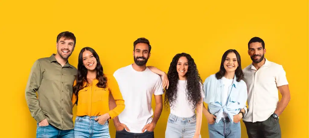 Groupe de personnes souriantes sur fond jaune.