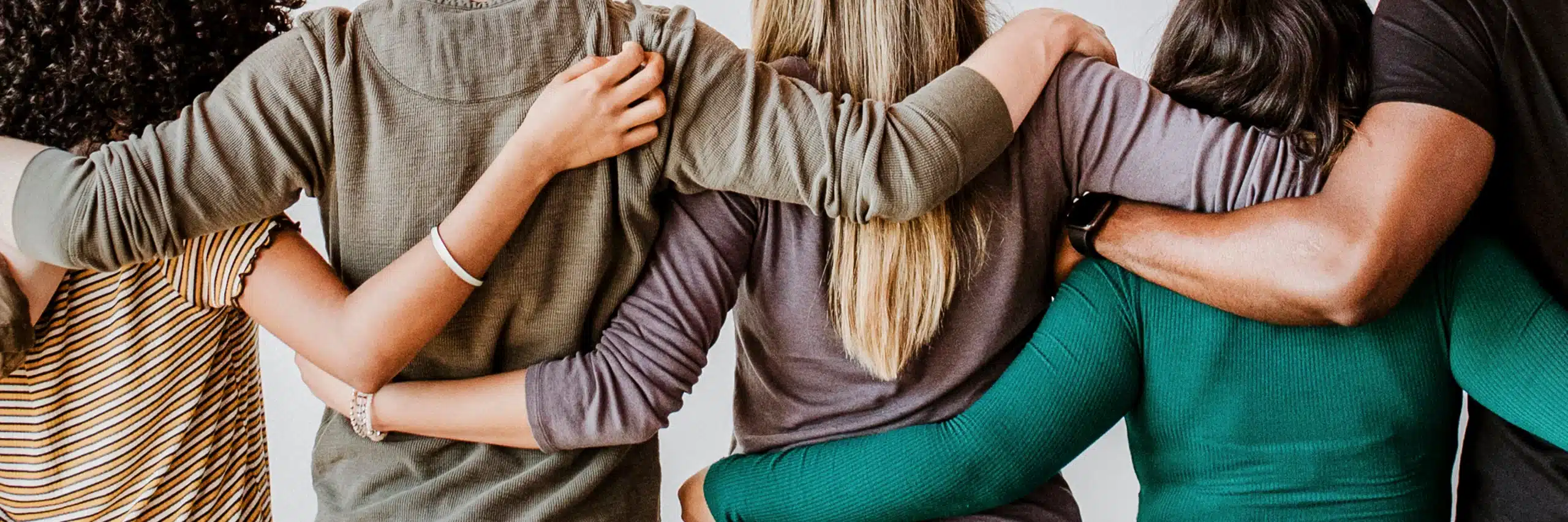 Group of friends embracing each other joyfully